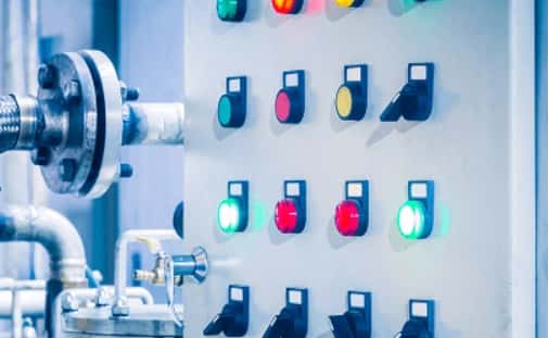 male electrician works switchboard